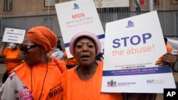 FILE - Activists of South African women's rights groups demonstrate against gender-based violence, outside the magistrate court in Johannesburg, South Africa, Oct. 18, 2022.