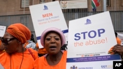FILE - Activists of South African women's rights groups demonstrate against gender-based violence, outside the magistrate court in Johannesburg, South Africa, Oct. 18, 2022.
