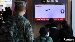 People watch a TV broadcasting a news report on North Korea firing three ballistic missiles into the sea, in Seoul, South Korea, Nov. 2, 2022. (Yonhap via Reuters)