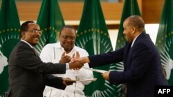 FILE: Representatives of the Ethiopian government, and the Tigray People's Liberation Front (TPLF), shake hands forging a peace agreement between the two parties in Pretoria on November 2, 2022