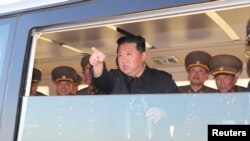 North Korean leader Kim Jong Un gestures as he watches the test-firing of a new-type tactical guided weapon according to state media, North Korea, in this undated photo released on April 16, 2022 by North Korea's Korean Central News Agency (KCNA). 