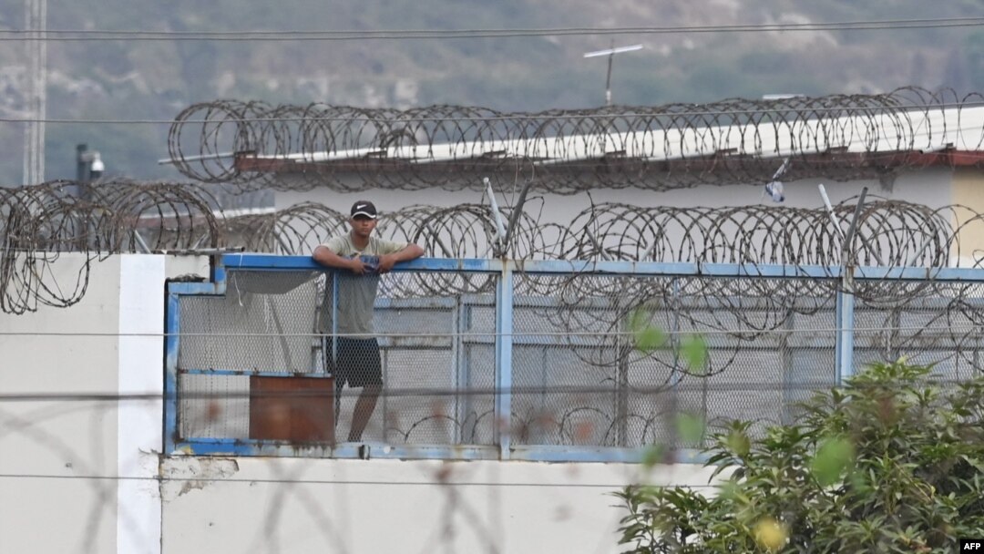 An inmate stands on the roof of the Litoral Penitentiary in Guayaquil, Ecuador, on Nov. 2, 2022. Police and soldiers on Wednesday patrolled the terror-stricken streets of two Ecuadorian cities after a spate of attacks blamed on organized crime groups waging a deadly drug war.