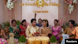 Leang Phannara and Kim Bethyliza attend their traditional Khmer wedding ceremony after it was delayed for months due to the coronavirus disease (COVID-19) restrictions in Phnom Penh, Cambodia January 29, 2021. (REUTERS/Cindy Liu) 