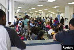 FILE - People fill the waiting area of a Pennsylvania Department of Transportation office in Philadelphia as they wait to get a voter ID card, Sept. 27, 2012.