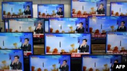 Television screens show a news report about the latest North Korean missile launch with file footage of a North Korean missile test, at an electronic market in Seoul, South Korea, Nov. 3, 2022. 