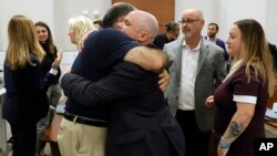 Majk Šulman i Ilan Alhadef grle se u sudnici na Floridi u pauzi na pretresu izricanja presude. Šulmanov sin Skot Bajgel i Alhadefova ćerka Alisa su ubijeni u pucnjavi 2018.