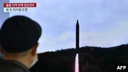 A man watches a television screen showing a news broadcast with file footage of a North Korean missile test, at a railway station in Seoul on Nov. 2, 2022. North Korea began Nov. 3 by by launching three missiles, including one that prompted emergency shelter orders in Japan.