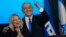 Former Israeli Prime Minister and the head of Likud party Benjamin Netanyahu and his wife, Sara, celebrate after first exit poll results for the Israeli Parliamentary election at his party's headquarters in Jerusalem, Nov. 2, 2022.