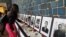 Photos of journalists killed for their work across the Americas in 2022 are displayed at an exhibition, "Memory and Voice," at the Organization of American States headquarters in Washington. (Tomás Guevara/VOA)