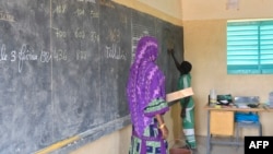 FILE - A teacher leads her classroom in a school on the outskirts of Ouallam, Niger, on Oct. 26, 2022. Africa needs to recruit at least 15 million teachers by 2030 to address a shortage in primary and secondary schools, UNESCO says.