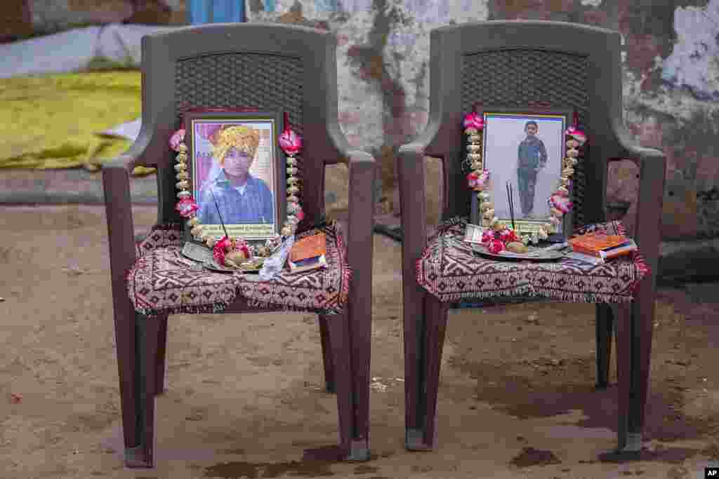 Garlands decorate the photograph of Yash Devadana, 12, left, and his cousin Raj Baghwanji Bhai, 13, victims of a bridge collapse, outside their house in Morbi town of western state Gujarat, India.