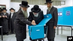 Ultra-Orthodox Jews watch as their Rabbi Israel Hager votes during Israel elections in Bnei Brak. Israel is holding its fifth election in less than four years. 