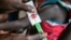 In this photo released by the World Food Programme (WFP) on Nov. 3, 2022, a woman is screened for malnutrition at a Nyong Primary Health Care Unit nutrition site in South Sudan where the WFP is offering supplementary feeding to children, pregnant and lactating women. 