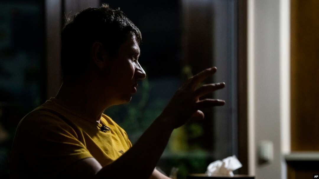 Yaroslav Vedmid talks with the Associated Press in a village during a blackout on the outskirts of Kyiv, Ukraine, Oct. 27, 2022. Since early October, Russian attacks on Ukraine's energy infrastructure have triggered power cuts across the country.