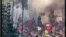 This image grab from a UGC video posted on Nov. 1, 2022, reportedly shows security forces trying to enter a closed shopping center on Amir Kabir street in Iran's capital Tehran before being engulfed by gas matter. (UGC via AFP)