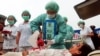 FILE – Falun Gong practitioners simulate organ harvesting in a mock Chinese labor camp in front of the Presidential Office in Taipei, Taiwan, April 23, 2006, in protest against China's suspected abuse and killing of Falun Gong members. 