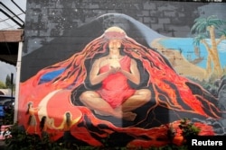 A mural of the Hawaiian goddess Pele is depicted on a wall of a local art gallery in Pahoa, Hawaii, May 25, 2018.