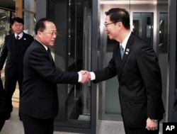 In this photo provided by S. Korea Unification Ministry, S. Korean Vice Unification Minister Chun Hae-sung, right, shakes hands with the head of N. Korean delegation Jon Jong Su before their meeting at Panmunjom in the Demilitarized Zone .
