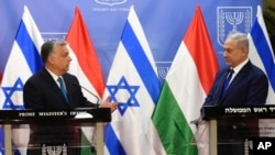 Hungarian Prime Minister Viktor Orban, left, speaks during a joint press conference with Israeli Prime Minister Benjamin Netanyahu, at the Prime Minister's office in Jerusalem, July 19, 2018.