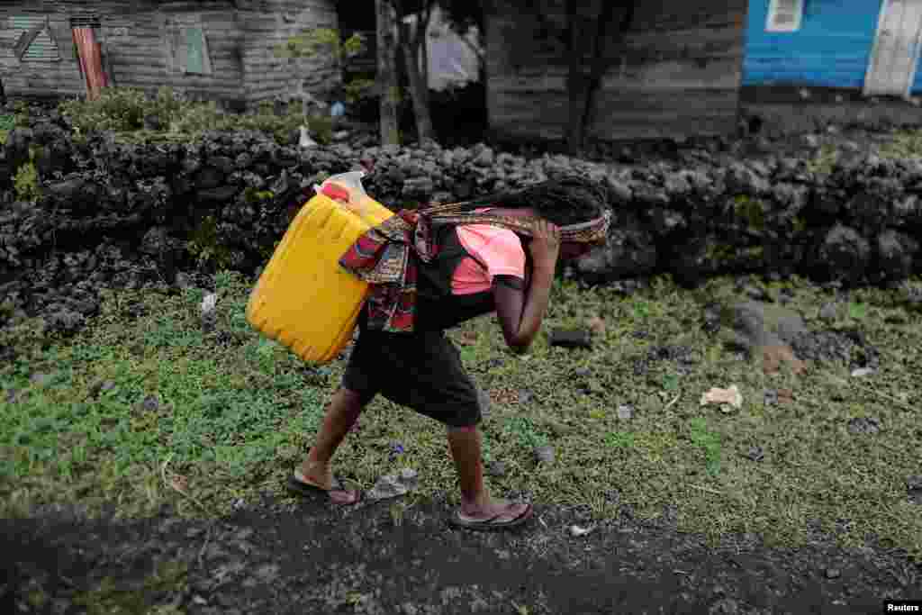 Chikuru, 11, carries water home in Bugamba district in Goma, the capital of North Kivu, eastern Democratic Republic of Congo, Sept. 30, 2019.