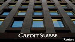 FILE - The Credit Suisse logo is pictured on a bank in Geneva, Switzerland, Oct. 17, 2017. 