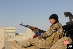 An Afghan National Army soldier rests after he arrives in a camp outside Kunduz city, north of Kabul, Afghanistan, Sept. 30, 2015.