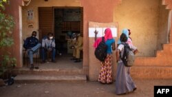 FILE - Students of the Madamou Goundo Simaga School look for their names on the class lists as they start a new school year, in Bamako, Mali, Jan. 25, 2021.