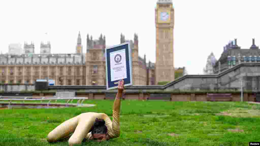 Liberty Barros is seen with her Guinness World Records&#39; certificate for doing the fastest 20m back bend knee lock, in London.