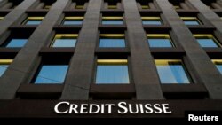 FILE - The Credit Suisse logo is pictured on a bank in Geneva, Switzerland, Oct. 17, 2017. 