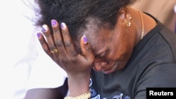 A woman mourns slain Ugandan Olympian Rebecca Cheptegei, who died after her partner doused her in gasoline and set her ablaze, before her burial in Bukwo, Uganda, on Sept. 14, 2024.