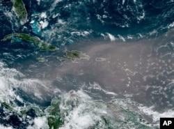 Foto de satélite de la Administración Nacional Oceánica y Atmosférica de Estados Unidos (NOAA) muestra la nube de polvo del Sahara a su llegada al Caribe el 22 de junio de 2020.
