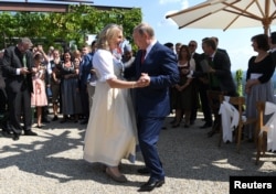 Austria's Foreign Minister Karin Kneissl dances with Russia's President Vladimir Putin at her wedding in Gamlitz, Austria, Aug. 18, 2018.