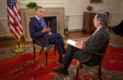 President Barack Obama during a 2011 interview with the Voice of America's Andre DeNesnera in the Map Room of the White House.