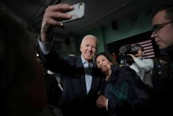 FILE - Democratic presidential candidate Joe Biden takes a selfie during a campaign stop in Exeter, N.H., Dec. 30, 2019.