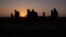 The sun rises as asylum-seeking migrant families from Honduras and El Salvador walk towards the border wall after crossing the Rio Grande River into the United States from Mexico on a raft, in Penitas, Texas on Mar 26, 2021. (REUTERS/Adrees Latif)