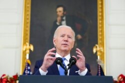 FILE - President Joe Biden speaks in the State Dining Room of the White House in Washington, Dec. 21, 2021.