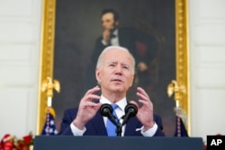 FILE - President Joe Biden speaks in the State Dining Room of the White House in Washington, Dec. 21, 2021.