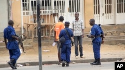Police arrest a man following grenade attacks in the capital Bujumbura, Burundi Wednesday, Feb. 3, 2016.