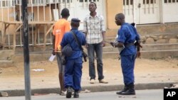 FILE - Police arrest a man following grenade attacks in the capital Bujumbura, Burundi Wednesday, Feb. 3, 2016.