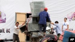 FILE - Workers remove air ducts made from aluminum sheet metal in Beijing, China, Aug. 22, 2016. On Thursday, the U.S. filed a complaint against China for allegedly giving its aluminum industry an unfair advantage by providing it with cheap loans and illegal subsidies.