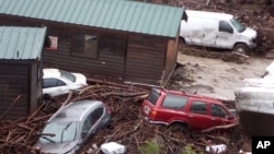 Cabins and vehicles are swept away by storm runoff at El Capitan Canyon Resort & Campground in Gaviota, Calif., Jan. 20, 2017.