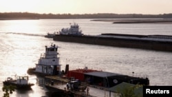 FILE - Barges make their way up the Mississippi River, where the water levels have reached record lows, in Memphis, Tennessee, Oct. 22, 2022. 