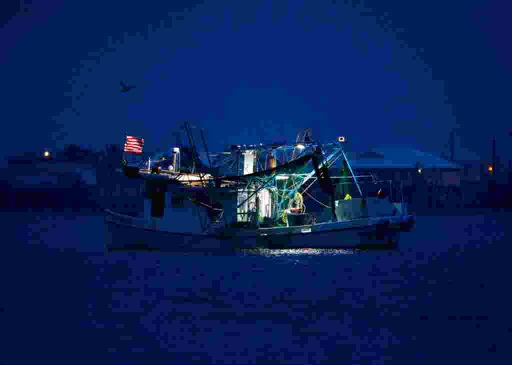 April 20: A commercial fishing boat sits anchored before sunrise in Grand Isle, La., a year after the Deepwater Horizon oil spill. (AP Photo/Patrick Semansky)