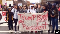 Protesters gather on the campus of the University of Connecticut to show their opposition to the election of Republican Donald Trump as president on Nov. 9, 2016 in Storrs, Conn.