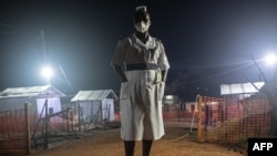 Jane Apunyo, a head nurse at Mubende referral hospital, stands watch during night supervision at the Ebola treatment center in Mubende, Uganda. 