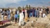 FILE - Mourners bury the body of a person killed when gunmen fired on vehicles carrying Shiite Muslims, after funeral prayers in Parachinar, the main town of Kurram district of Pakistan's northwestern Khyber Pakhtunkhwa province, Nov. 22, 2024.