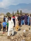 FILE - Mourners bury the body of a person killed when gunmen fired on vehicles carrying Shiite Muslims, after funeral prayers in Parachinar, the main town of Kurram district of Pakistan's northwestern Khyber Pakhtunkhwa province, Nov. 22, 2024.