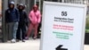 FILE - A trilingual sign directs people waiting to be led into a downtown Chicago building where an immigration court presides on Nov. 12, 2024. The White House said on Feb. 28, 2025, that President Donald Trump will designate English as the U.S.'s official language.