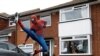 Jason Baird dressed as Spiderman exercises to cheer up local children in Stockport as the spread of the coronavirus disease (COVID-19) continues in Britain.