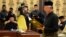 Malaysia's Prime Minister Najib Razak (R) reads his oath declaration in front of Malaysia's King Abdul Halim Mu'adzam Shah (not pictured) as he is sworn in for his second term as prime minister at the National Palace in Kuala Lumpur, May 6, 2013.